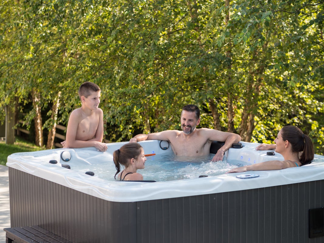 Family enjoying warm water and conversation in a Hydro Spa hot tub